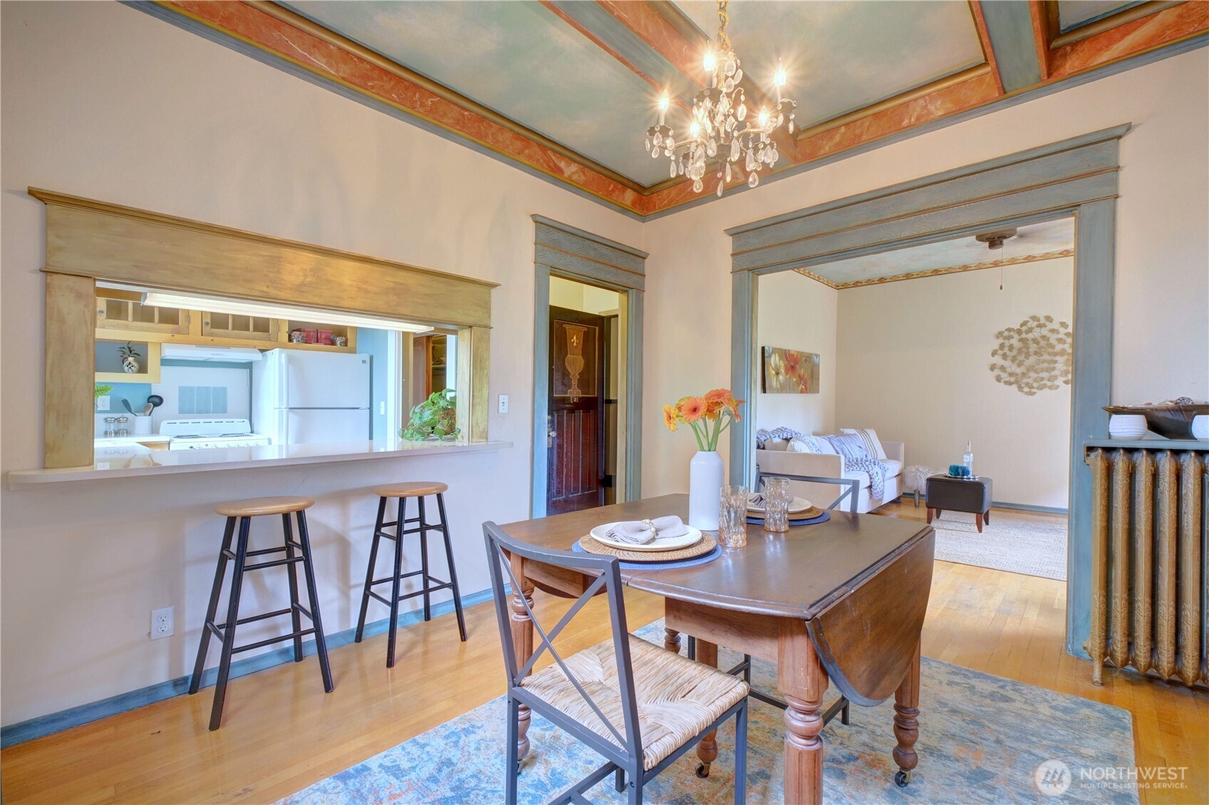 409 16th Avenue East, Unit 21 Seattle, WA 98112 - Photo 8 of 25 a dining room with furniture a chandelier and wooden floor