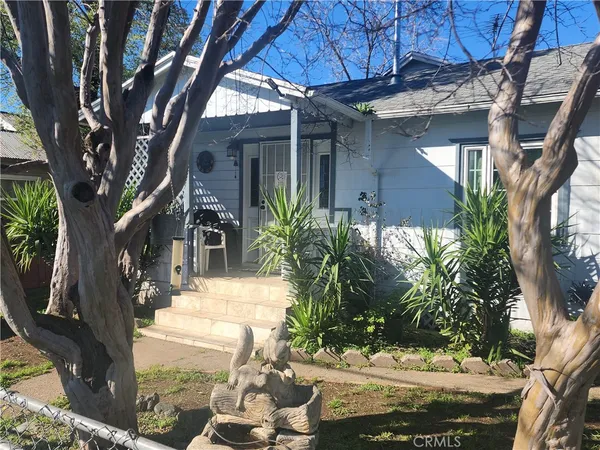 a view of a house with a yard and tree s