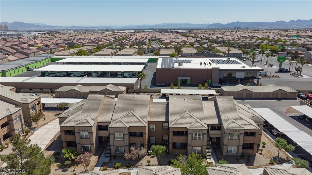 6650 West Warm Springs Road, Unit 2027 Las Vegas, NV 89118 - Photo 28 of 29 An aerial view showcases a vibrant community with diverse architecture under a clear sky.