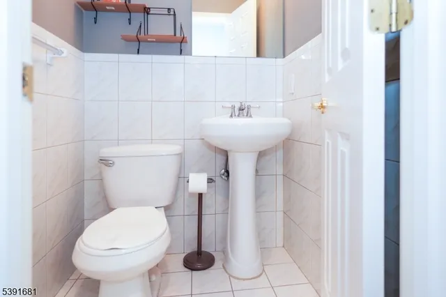 a bathroom with a sink toilet and a mirror