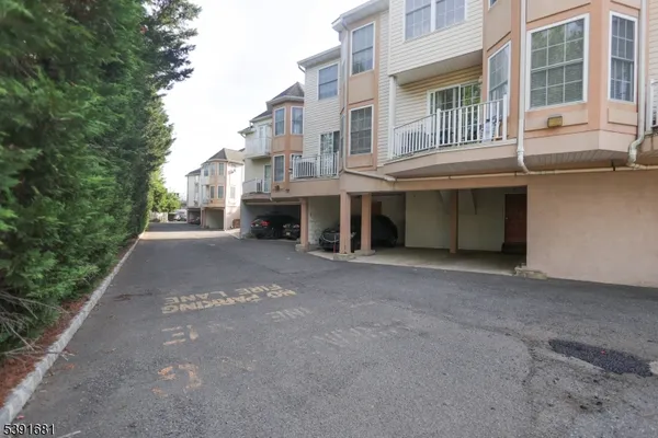 a view of a building with a yard and sitting area