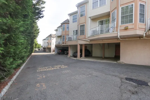 a view of a building with a yard and sitting area