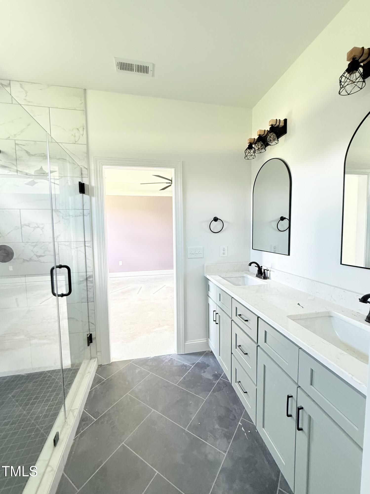 6930 Fire Tower Road Spring Hope, NC 27882 - Photo 19 of 33 a spacious bathroom with a double vanity sink mirror and shower
