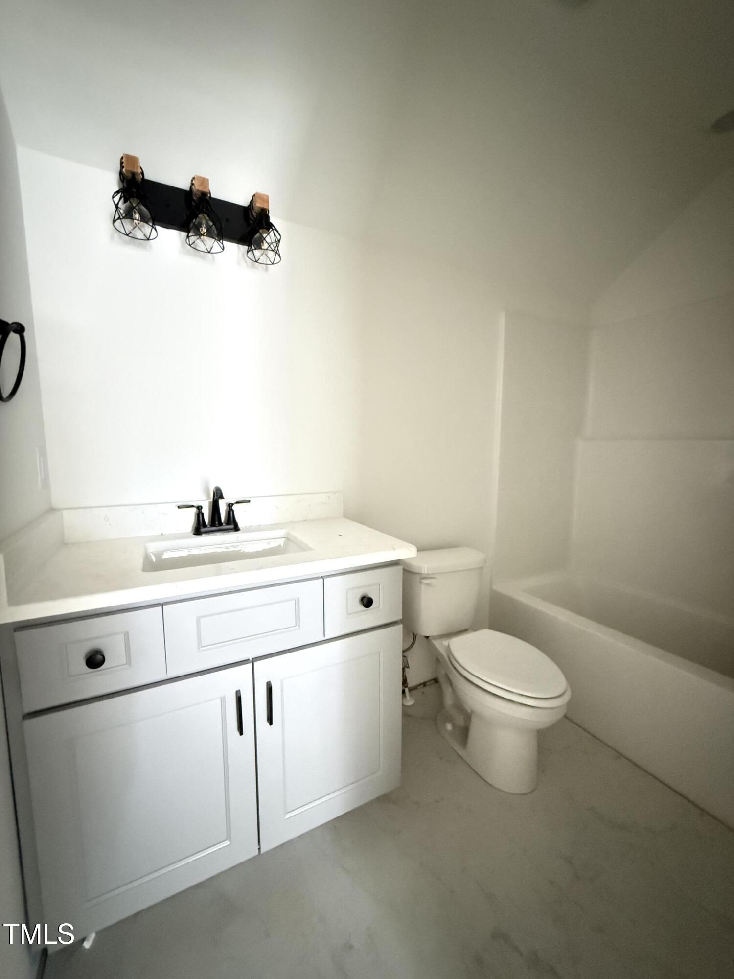 6930 Fire Tower Road Spring Hope, NC 27882 - Photo 29 of 33 a bathroom with a sink a toilet and mirror