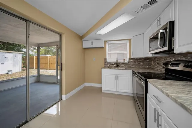 a kitchen with a stove a sink and a microwave