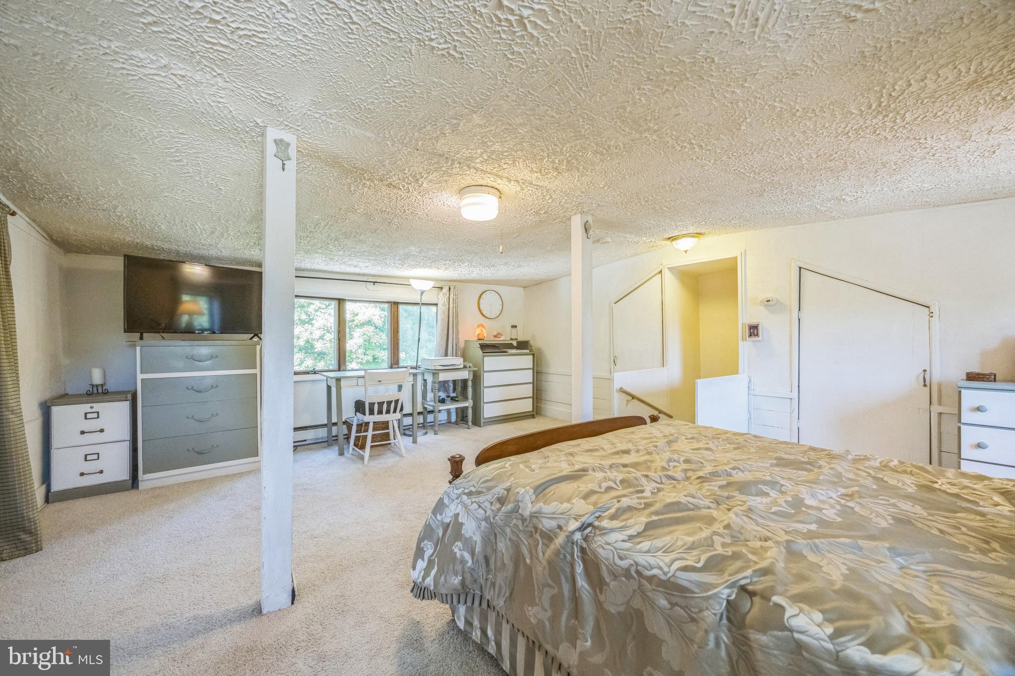 69 Oberlin Road Pennsville, NJ 08070 - Photo 11 of 21 a bedroom with a large bed and a tv