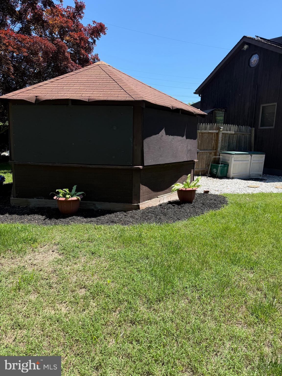 69 Oberlin Road Pennsville, NJ 08070 - Photo 19 of 21 a view of a backyard with table and chairs under an umbrella