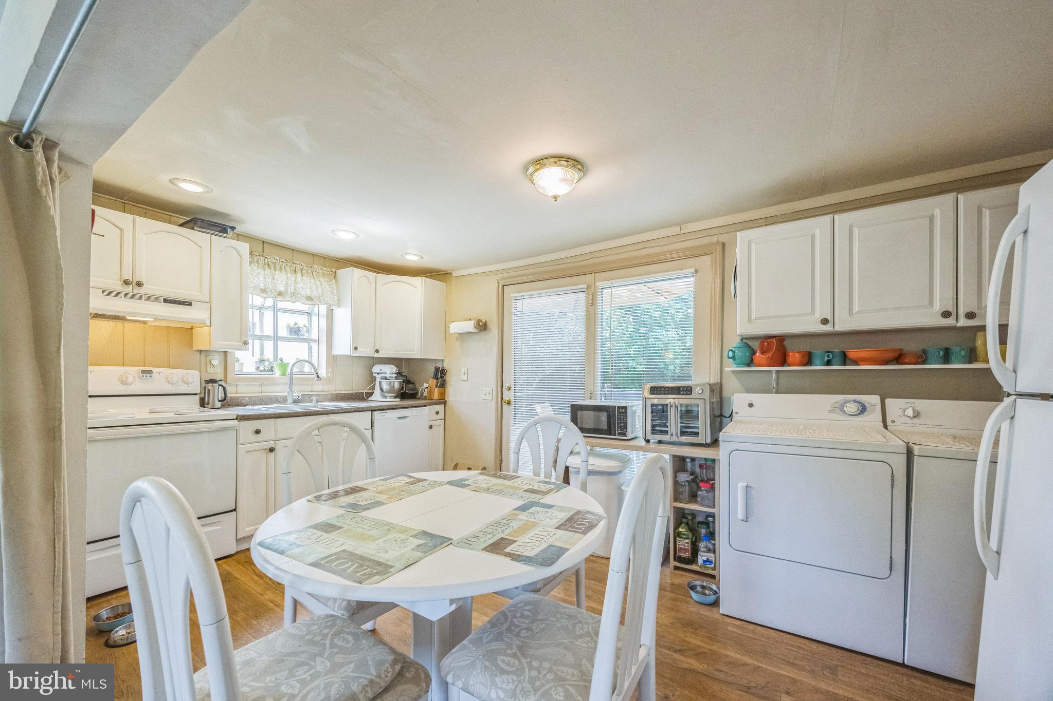69 Oberlin Road Pennsville, NJ 08070 - Photo 9 of 21 a kitchen with cabinets appliances and a table