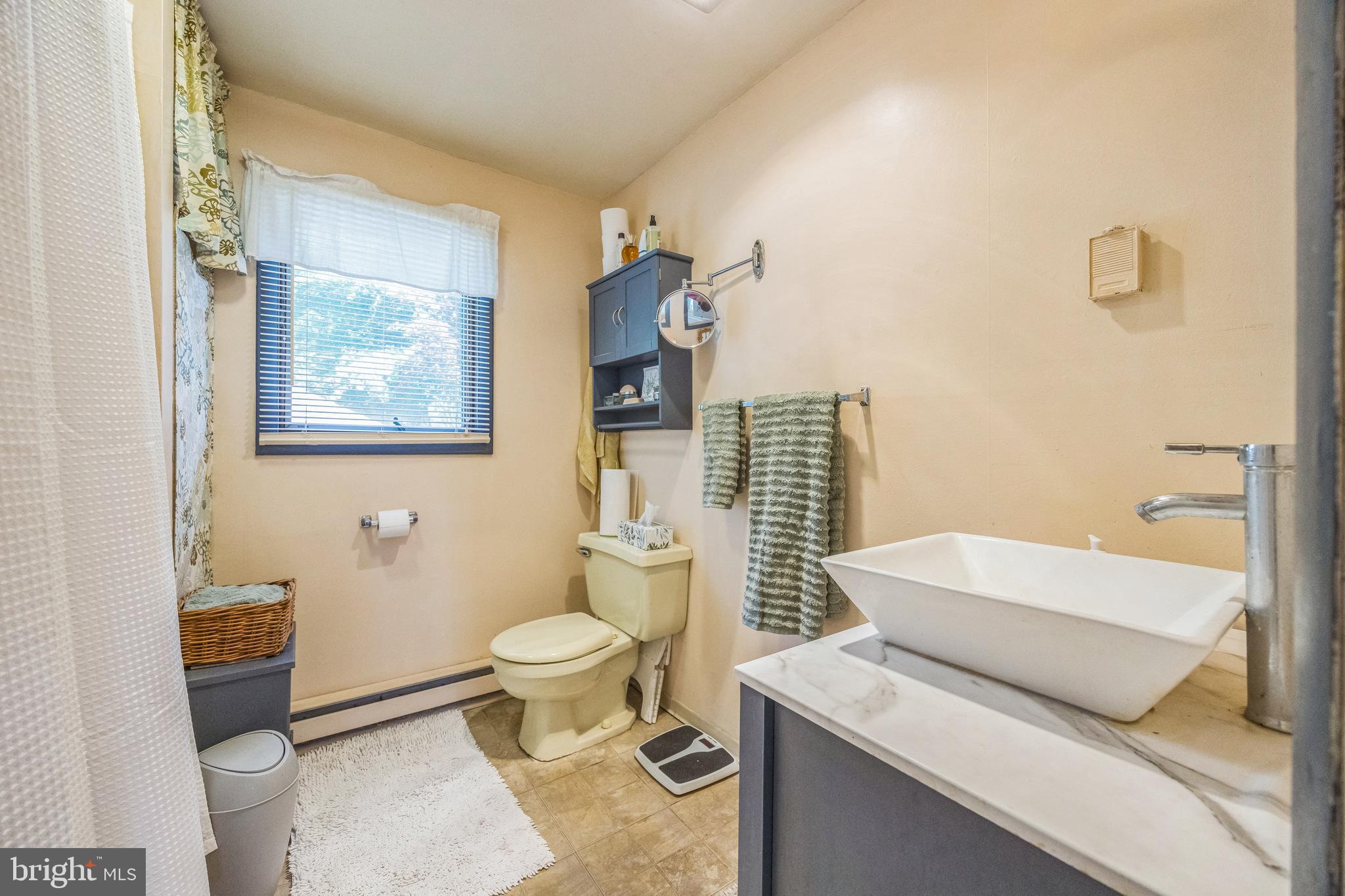69 Oberlin Road Pennsville, NJ 08070 - Photo 10 of 21 a bathroom with a sink a toilet and shower