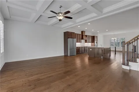 an empty room with a window and ceiling fan