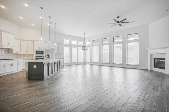 a view of kitchen with refrigerator microwave and wooden floor
