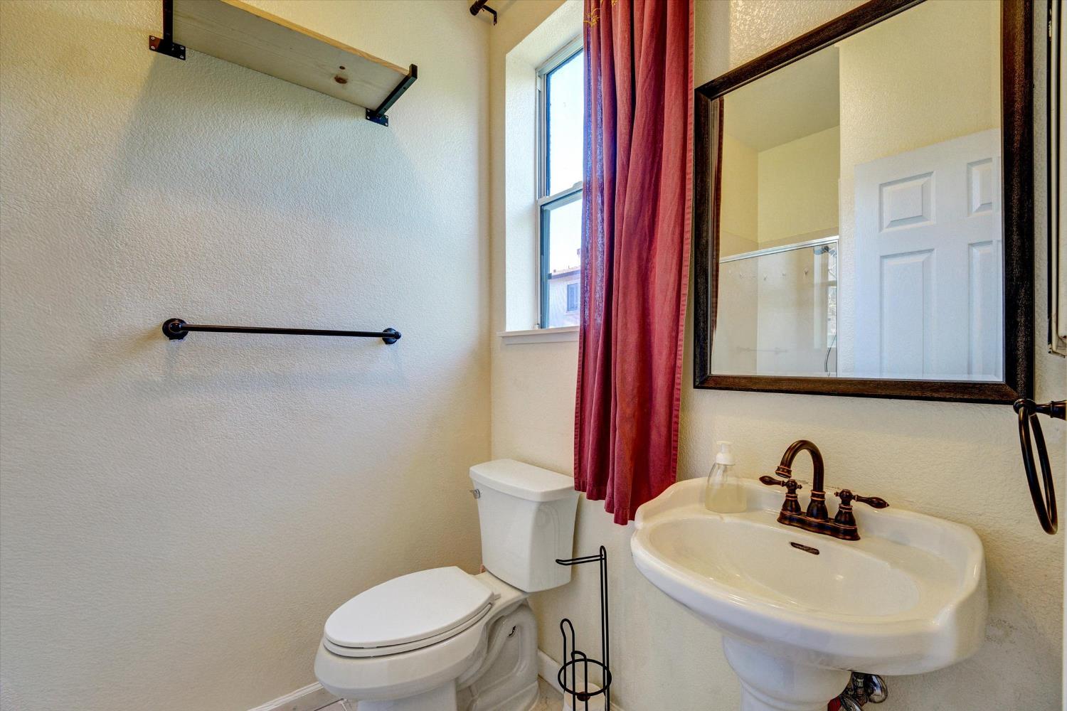 30253 Oakbrook Road Hayward, CA 94544 - Photo 16 of 49 a bathroom with a sink a toilet and a mirror