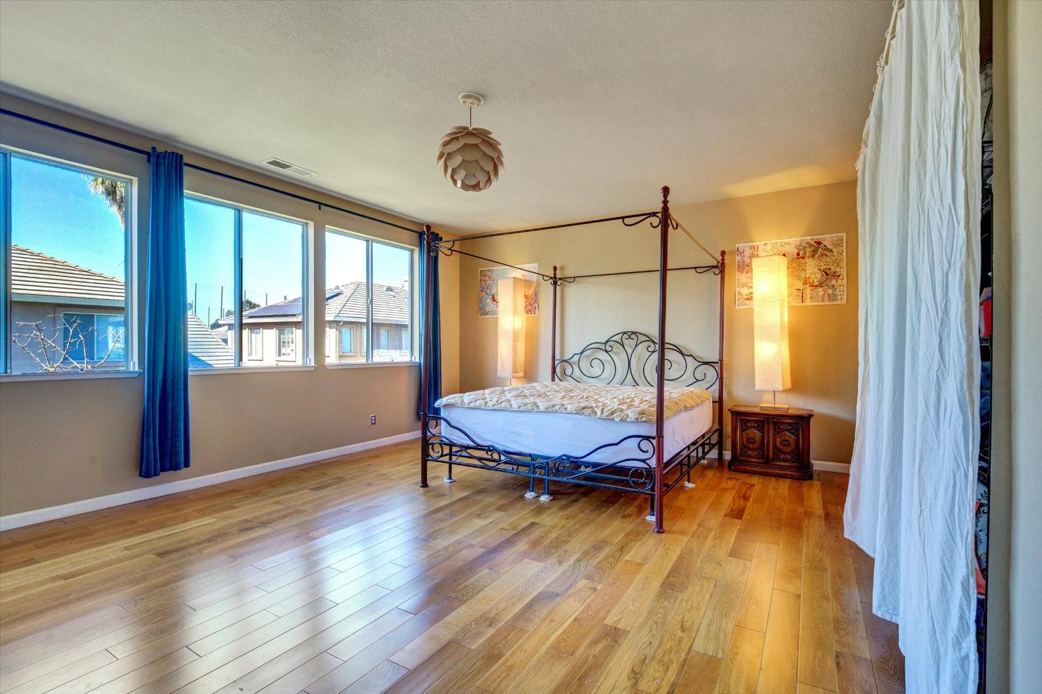 30253 Oakbrook Road Hayward, CA 94544 - Photo 26 of 49 a bedroom with a bed and wooden floor