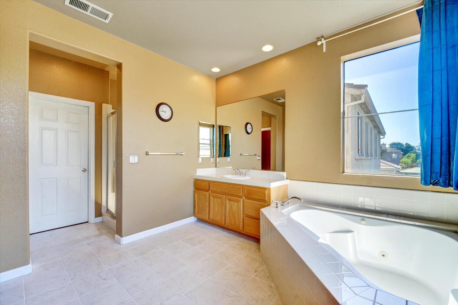 30253 Oakbrook Road Hayward, CA 94544 - Photo 29 of 49 a bathroom with a granite countertop tub sink and mirror