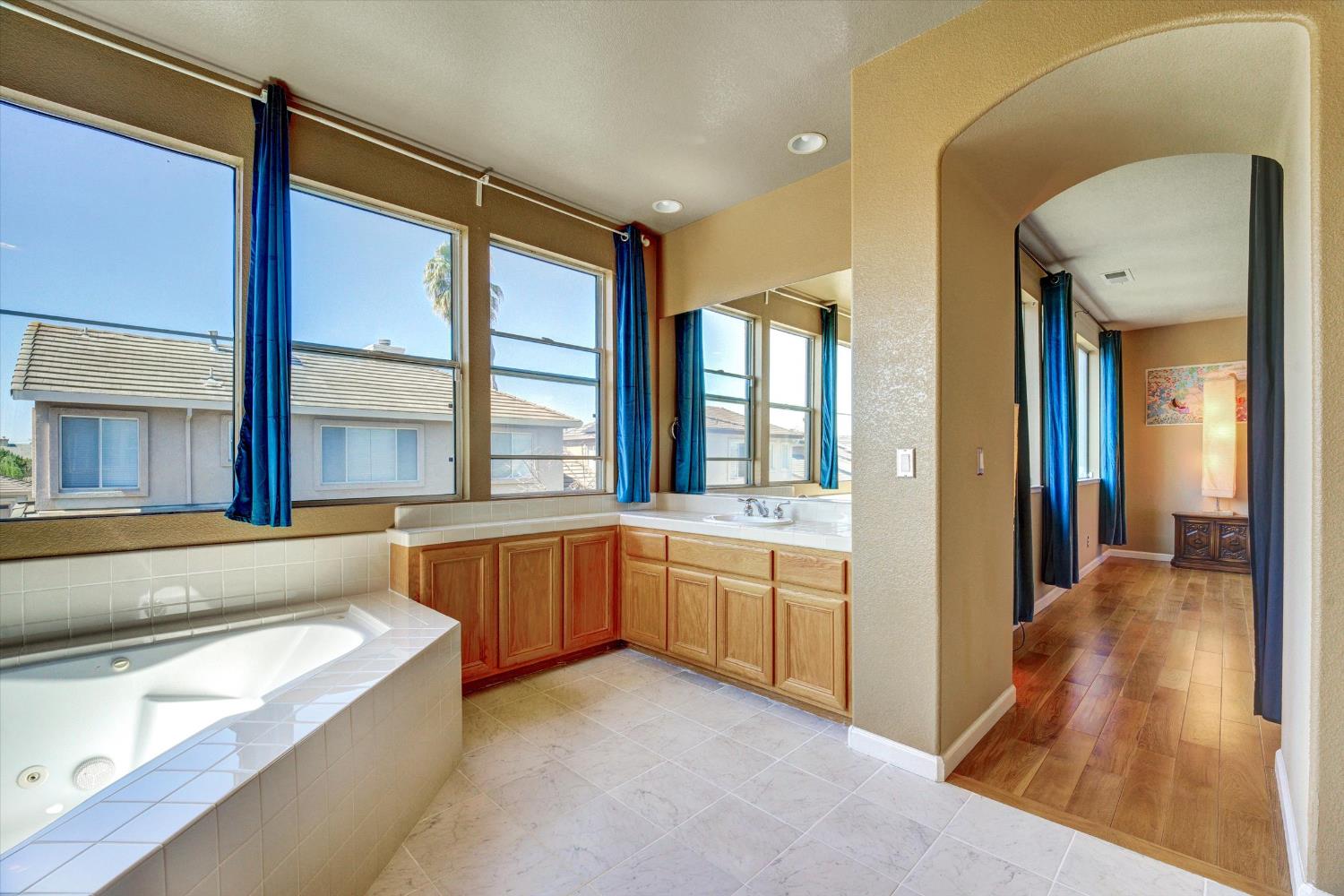 30253 Oakbrook Road Hayward, CA 94544 - Photo 30 of 49 a spacious bathroom with a granite countertop tub next to a large window