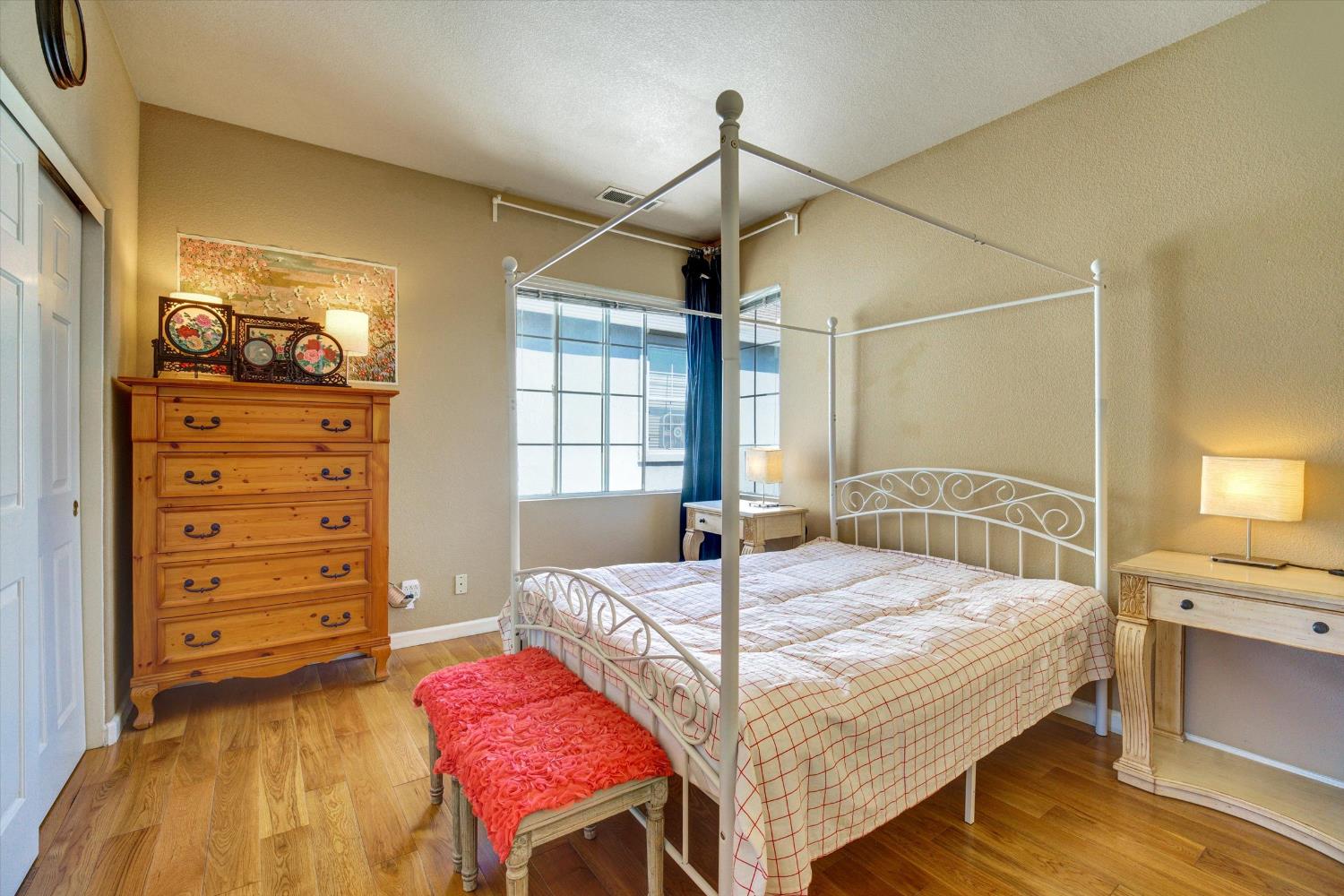 30253 Oakbrook Road Hayward, CA 94544 - Photo 35 of 49 a bedroom with a bed a chandelier and a dresser