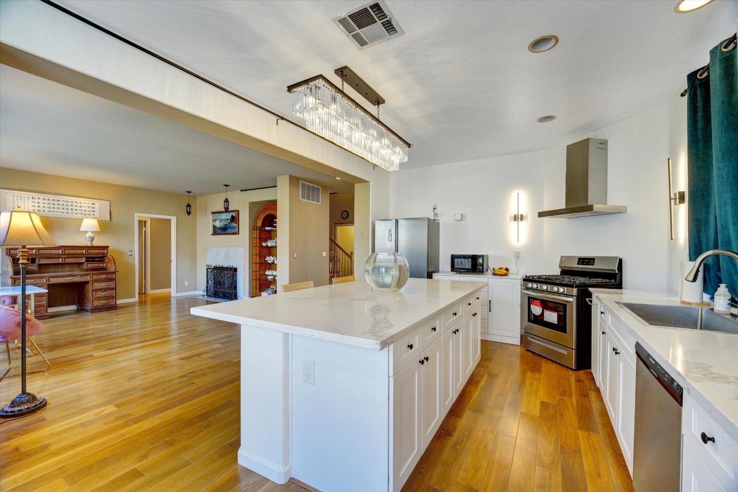 30253 Oakbrook Road Hayward, CA 94544 - Photo 6 of 49 a large kitchen with stainless steel appliances granite countertop a lot of counter space and wooden floor