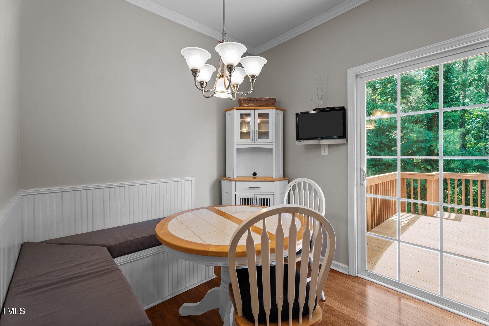 5310 Echo Ridge Road Raleigh, NC 27612 - Photo 12 of 29 a view of a dining room with furniture a chandelier and window