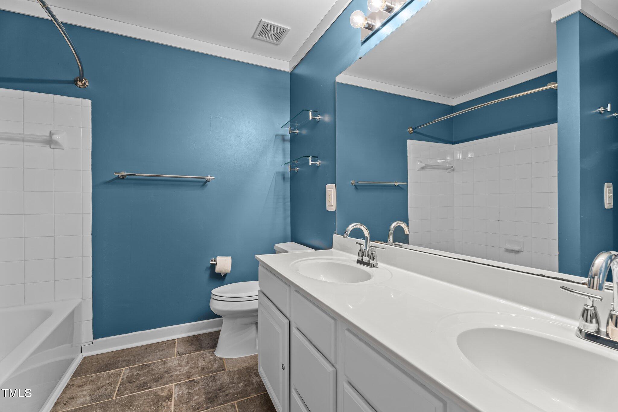 5310 Echo Ridge Road Raleigh, NC 27612 - Photo 17 of 29 a bathroom with a sink a toilet and a mirror