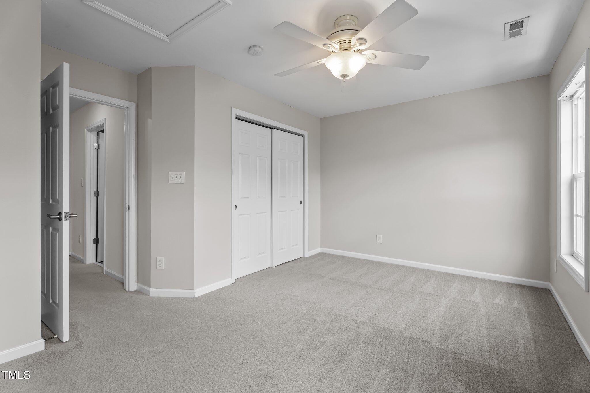 5310 Echo Ridge Road Raleigh, NC 27612 - Photo 18 of 29 an empty room with a ceiling fan and a window