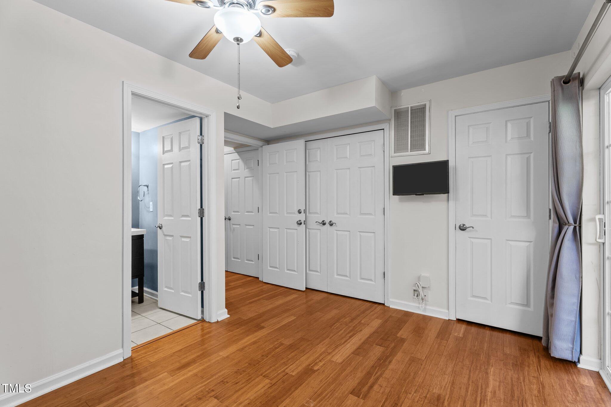 5310 Echo Ridge Road Raleigh, NC 27612 - Photo 21 of 29 a view of empty room with wooden floor and ceiling fan