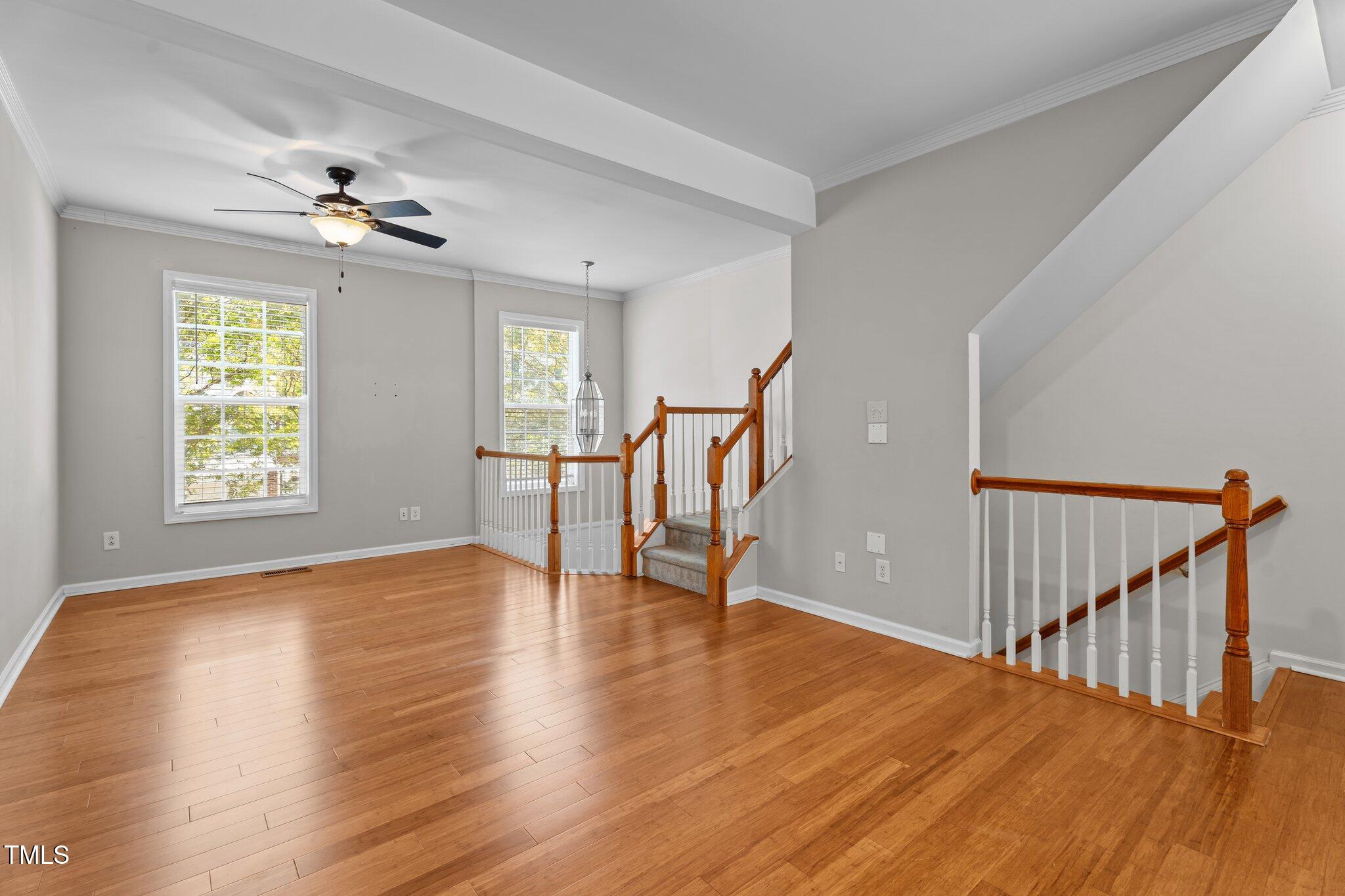 5310 Echo Ridge Road Raleigh, NC 27612 - Photo 5 of 29 a view of an empty room with a window and wooden floor