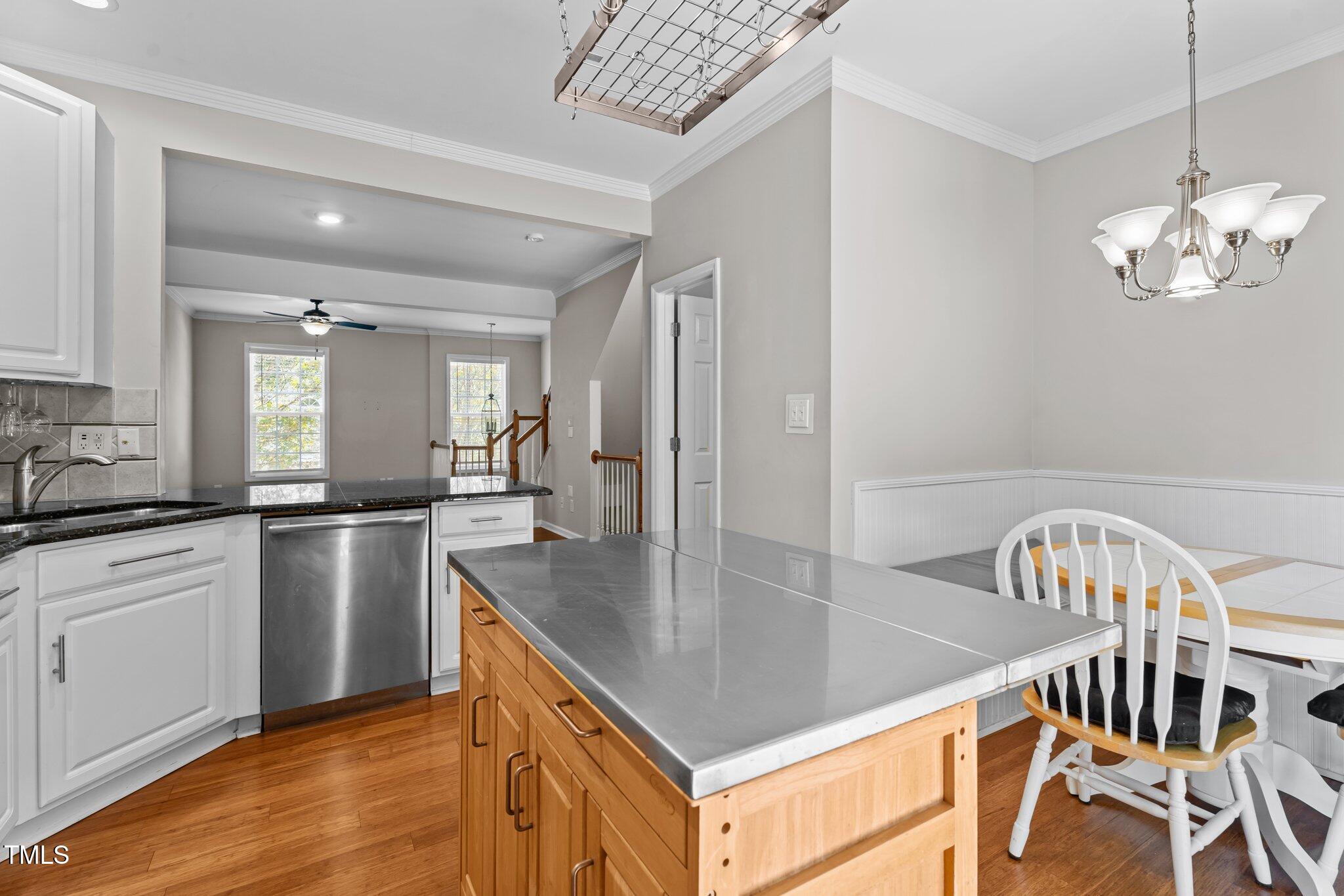 5310 Echo Ridge Road Raleigh, NC 27612 - Photo 9 of 29 a kitchen with stainless steel appliances granite countertop a kitchen island hardwood floor and a sink