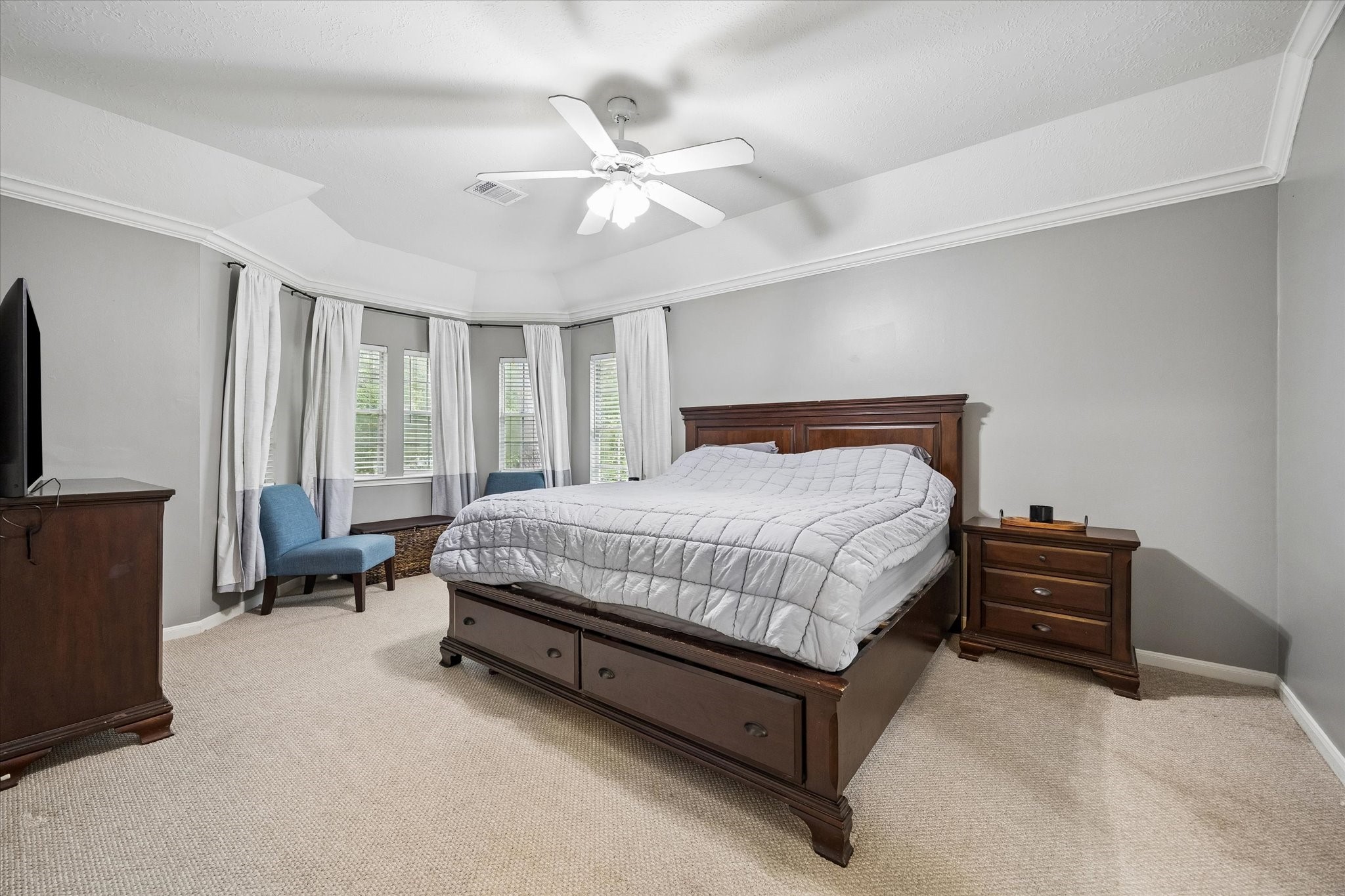 8123 Clarion Way Houston, TX 77040 - Photo 18 of 33 a bedroom with a bed couch and flat screen tv