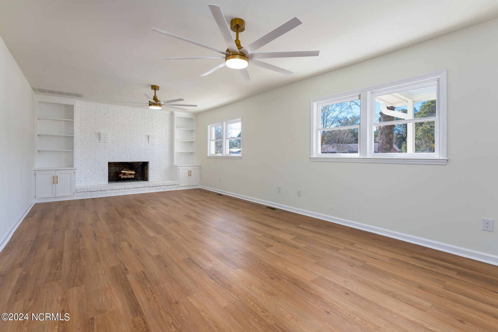 229 2 Chopt Road Wilmington, NC 28405 - Photo 19 of 73 Gorgeous living room w brick wood-burning fireplace and built-in shelving!