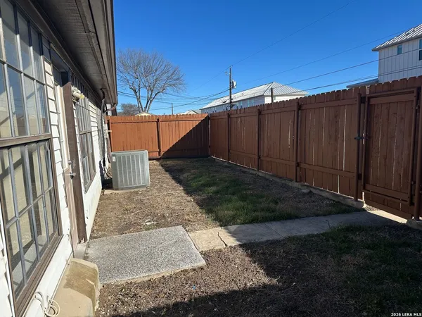 a view of a backyard with pathway