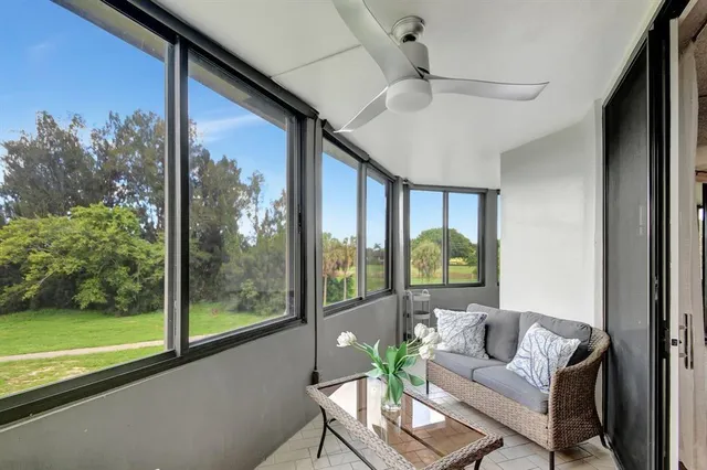 a living room with couch and a floor to ceiling window