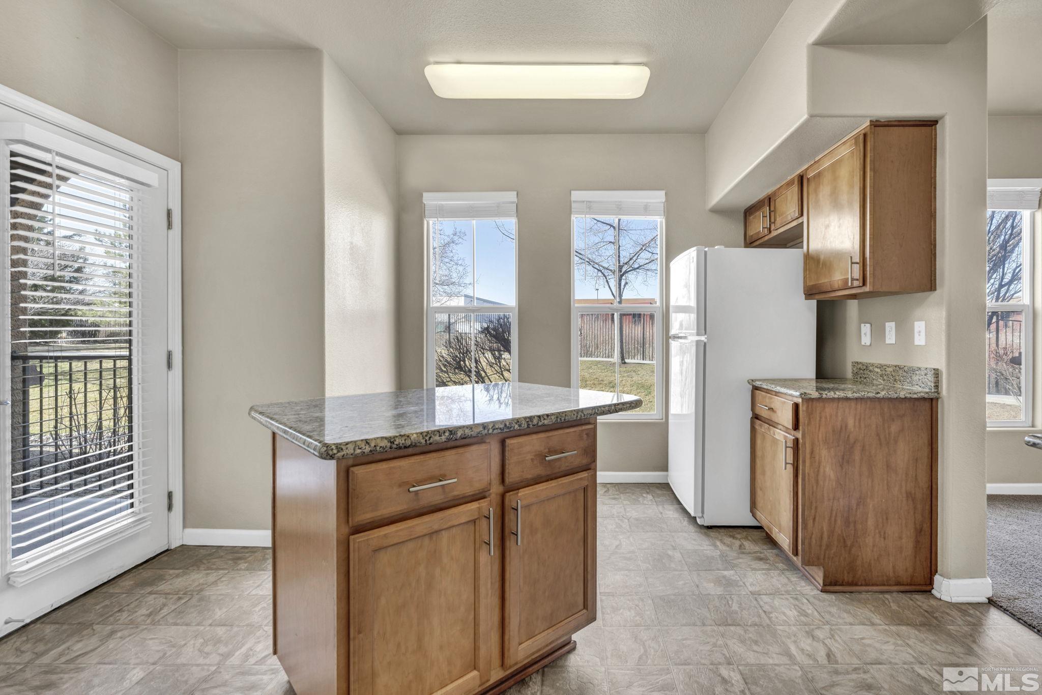 1325 South Meadows Parkway, Unit 412 Reno, NV 89521 - Photo 16 of 39 a kitchen with stainless steel appliances granite countertop a refrigerator and a stove