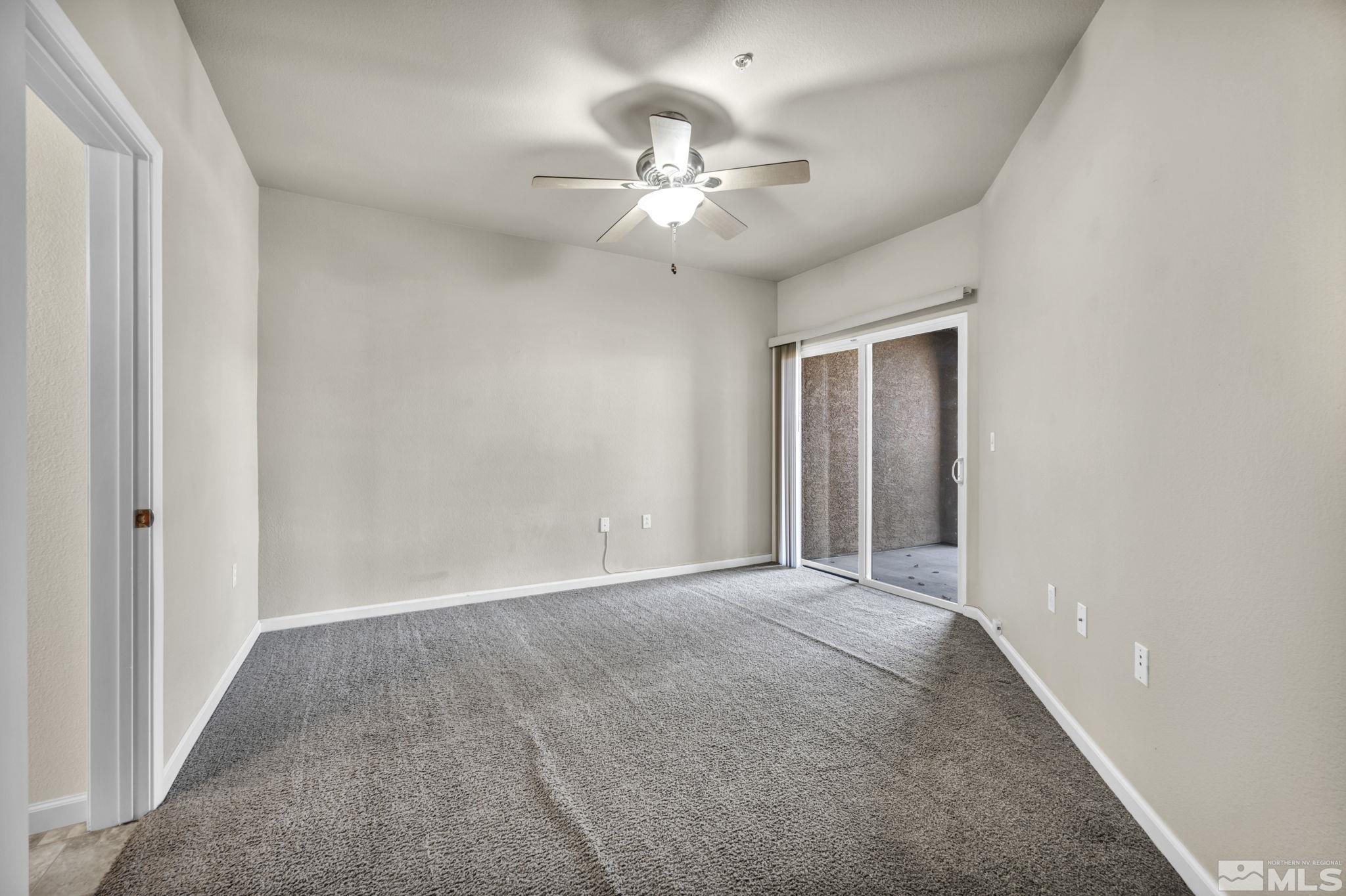 1325 South Meadows Parkway, Unit 412 Reno, NV 89521 - Photo 18 of 39 a view of an empty room with a chandelier fan