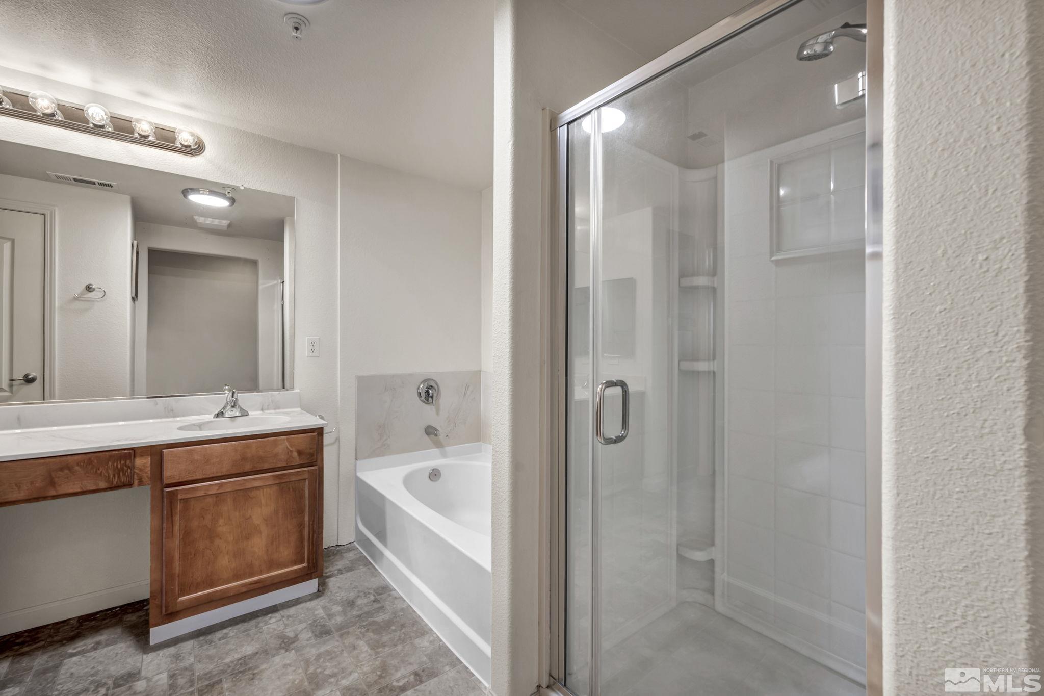 1325 South Meadows Parkway, Unit 412 Reno, NV 89521 - Photo 21 of 39 a bathroom with a bathtub shower and sink