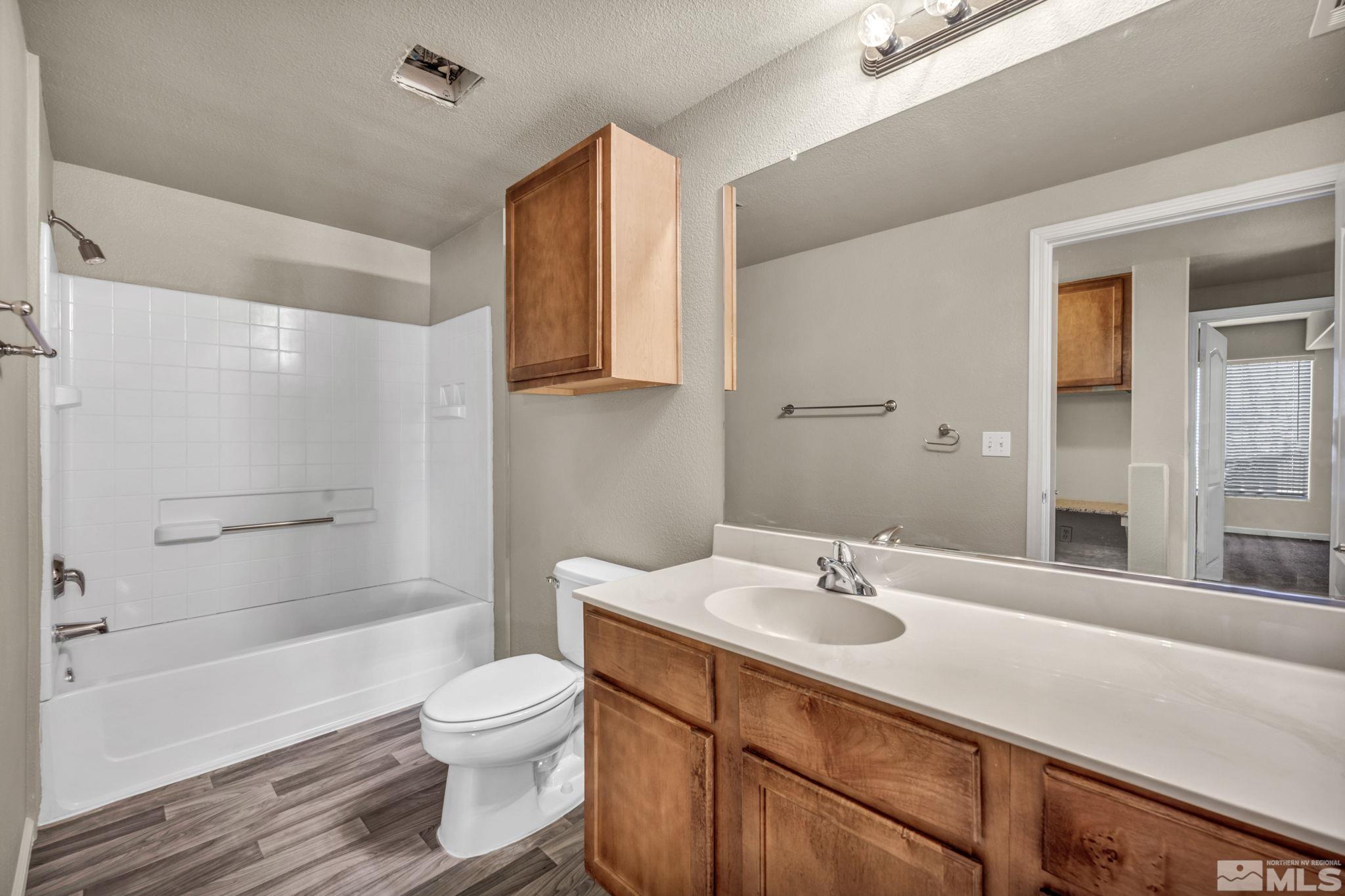1325 South Meadows Parkway, Unit 412 Reno, NV 89521 - Photo 29 of 39 a bathroom with a sink a toilet and shower
