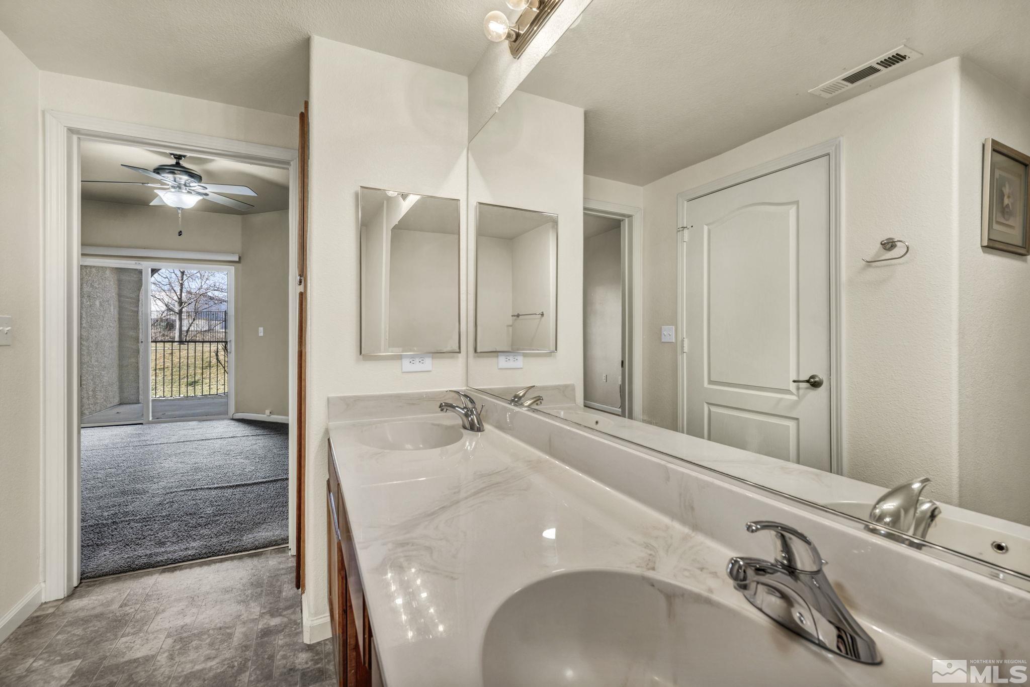 1325 South Meadows Parkway, Unit 412 Reno, NV 89521 - Photo 30 of 39 a bathroom with a sink and a mirror