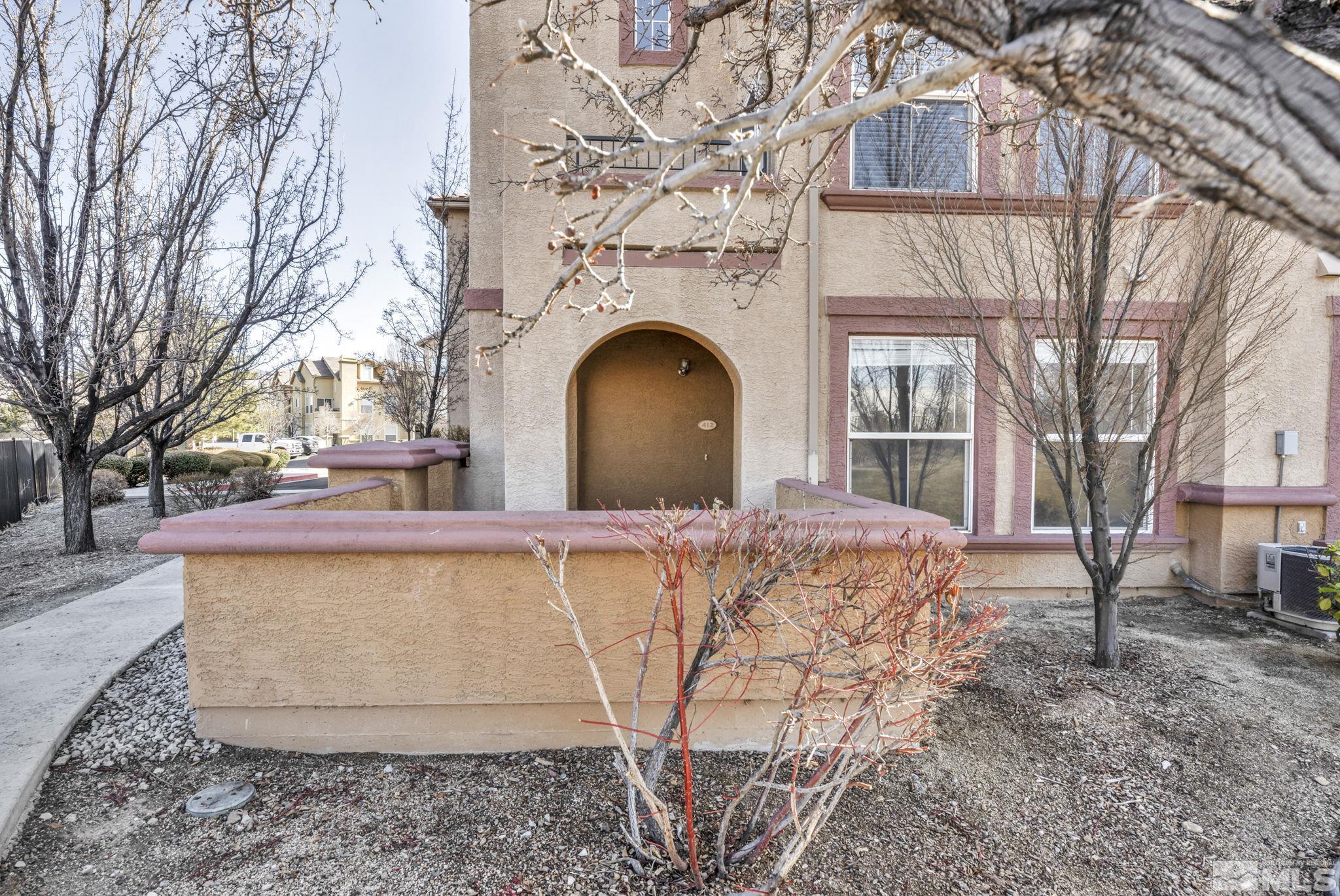 1325 South Meadows Parkway, Unit 412 Reno, NV 89521 - Photo 3 of 39 a view of a building with large trees