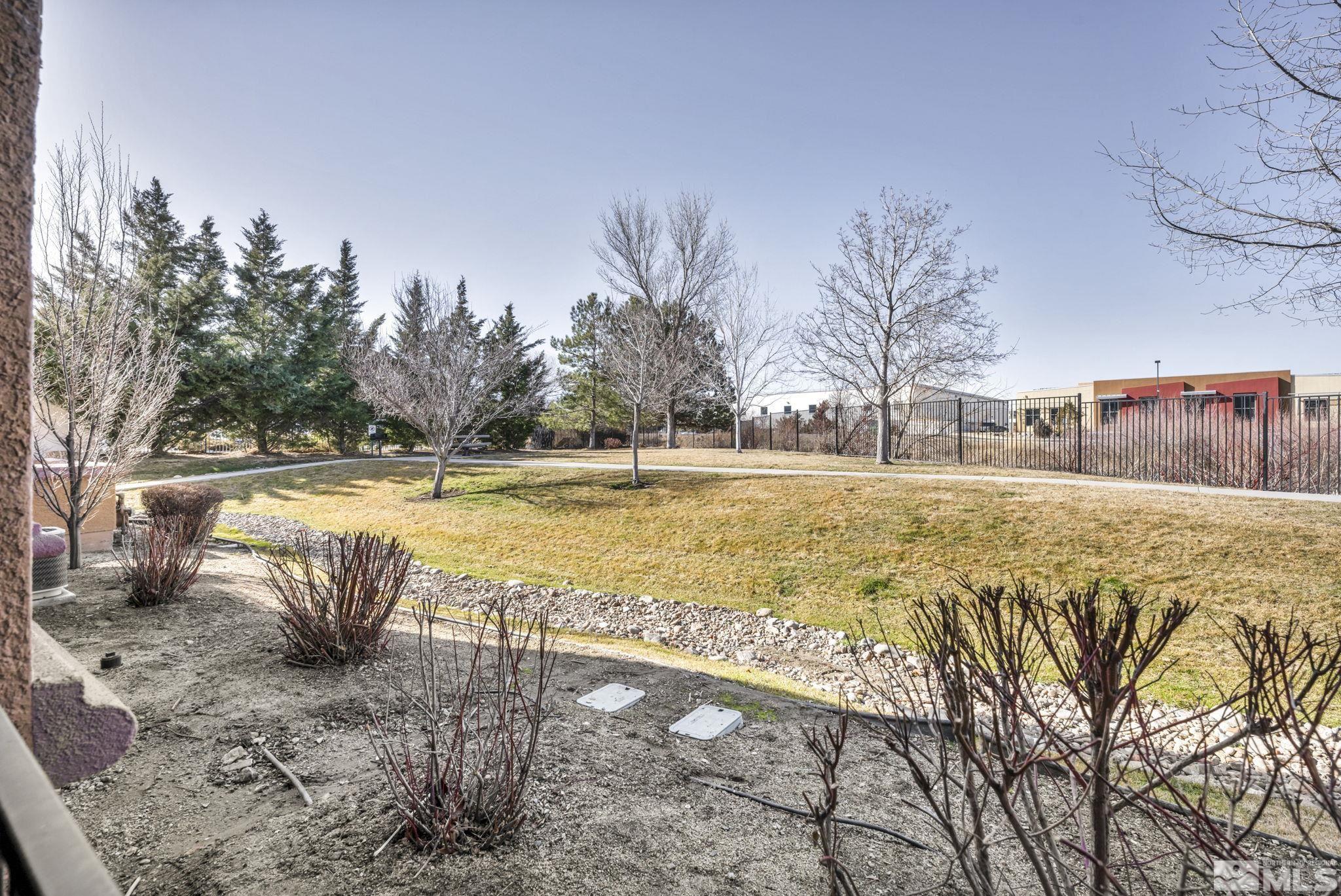 1325 South Meadows Parkway, Unit 412 Reno, NV 89521 - Photo 37 of 39 a view of swimming pool with lawn chairs and wooden fence