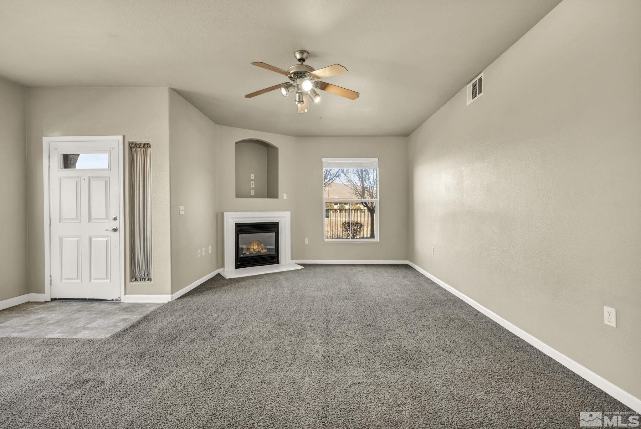 1325 South Meadows Parkway, Unit 412 Reno, NV 89521 - Photo 7 of 39 an empty room with windows and fireplace