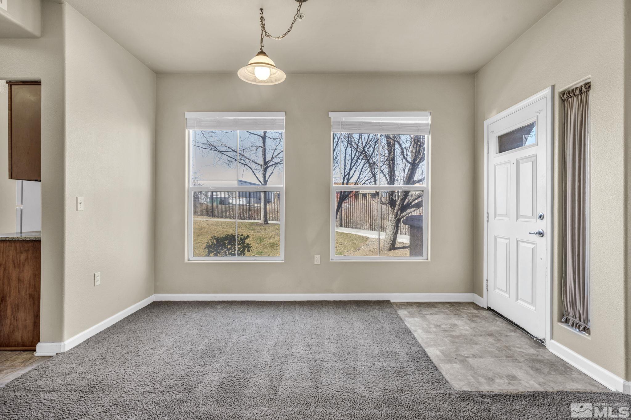 1325 South Meadows Parkway, Unit 412 Reno, NV 89521 - Photo 9 of 39 an empty room with windows lake and mountain view