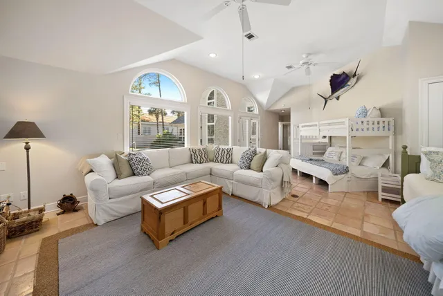 a view of a dining room and livingroom with furniture wooden floor a chandelier