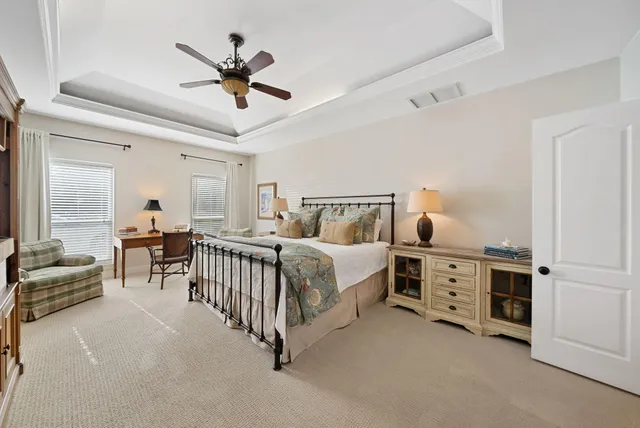 a bedroom with double bed and a chandelier