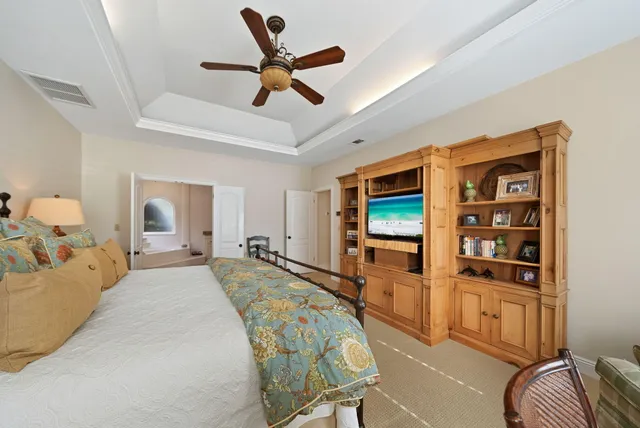 a bedroom with a bed and a lamp on the dresser