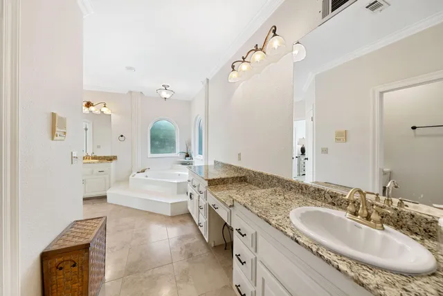 a bathroom with a sink vanity granite and a mirror