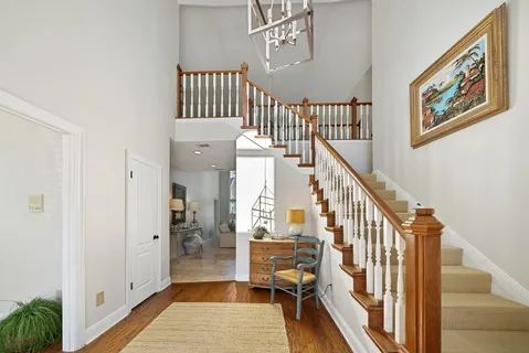 a living room with furniture and a chandelier