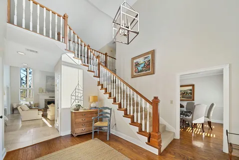 a dining room with furniture a chandelier and wooden floor