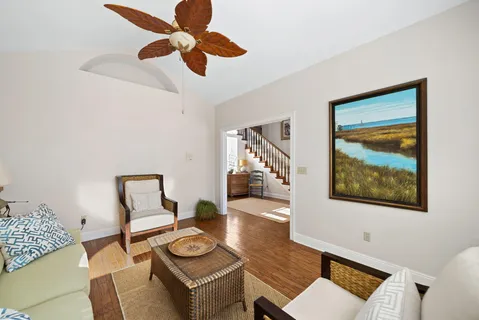 a bathroom with a granite countertop sink a mirror and a toilet