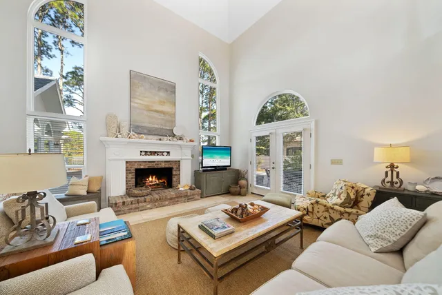 a living room with furniture and a chandelier