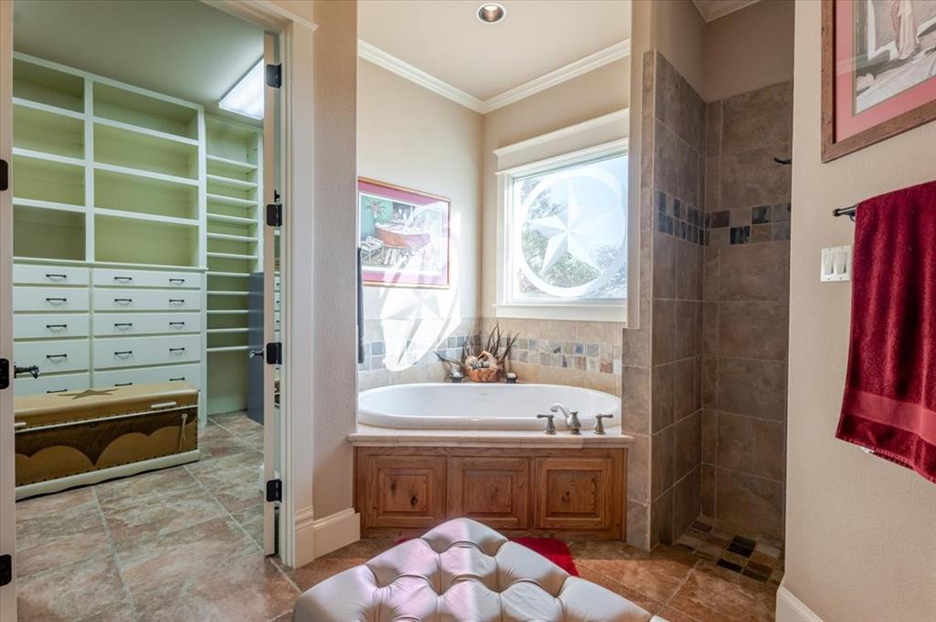 11918 Riek Road Krum, TX 76249 - Photo 19 of 39 a bathroom with a sink a toilet and tub