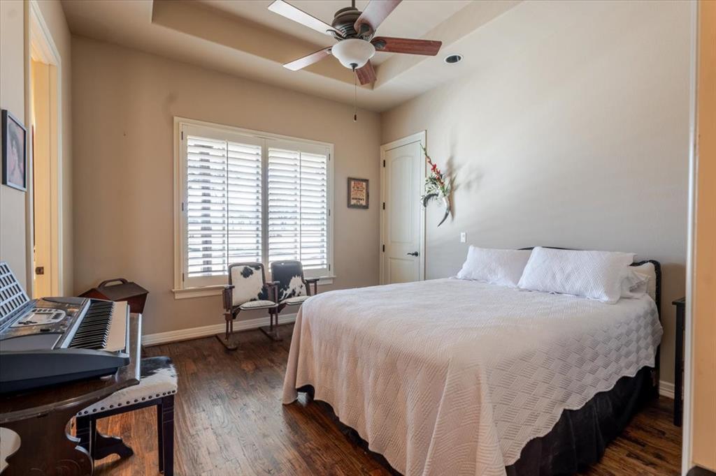 11918 Riek Road Krum, TX 76249 - Photo 22 of 39 a bedroom with a bed and a couch